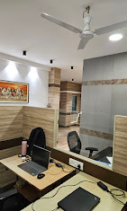 Office corridor with curated artwork at NRK Realtors